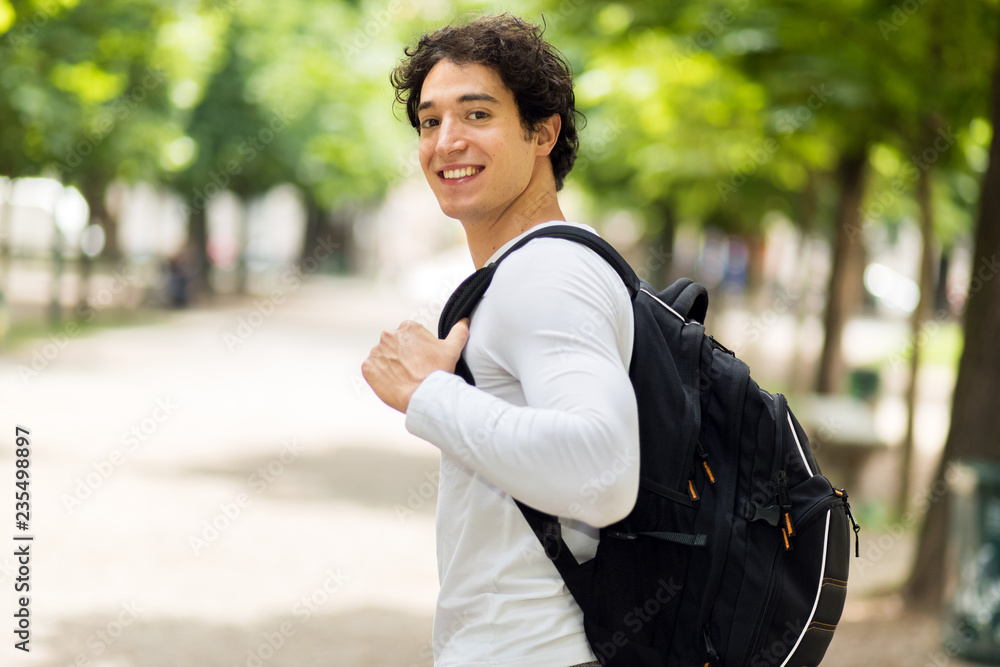 Smiling student outdoor in a college courtyard Smiling student outdoor in a college courtyard