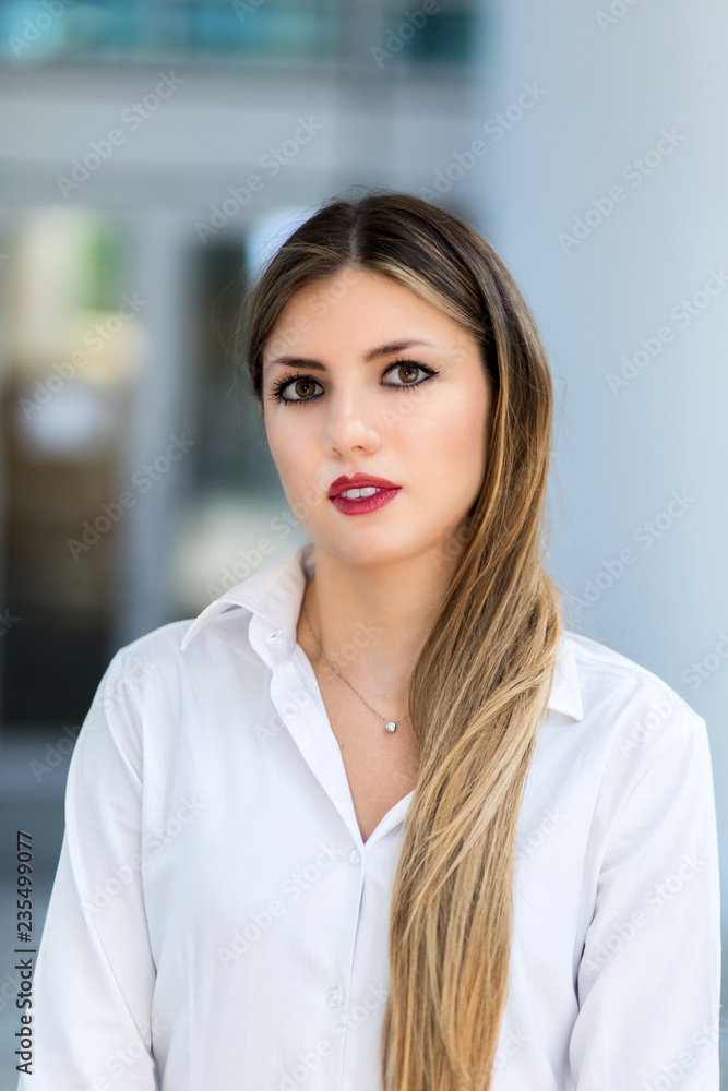 Confident young female manager outdoor in a modern urban setting Confident young female manager outdoor in a modern urban setting