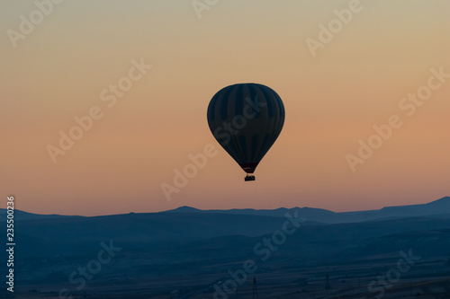 Cappadocia hot air balloon in the sky at sunrise sillouette © Ian