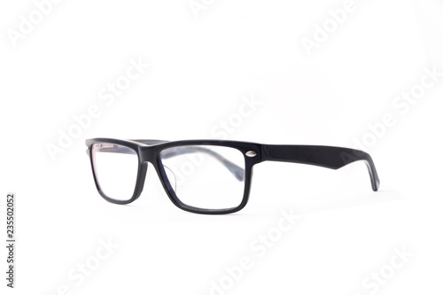 Rectangular black-rimmed glasses are located frontally on a white background. Isolated. side view
