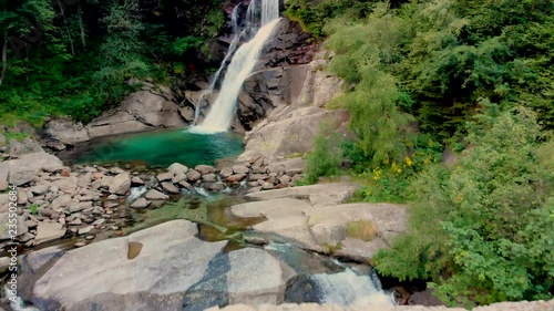 view to amasing waterfall in mountains photo