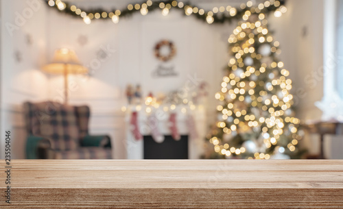 Empty wooden table over defocused christmas background with copy space