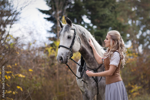 Young woman with a horse