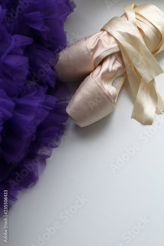 Ballet dance shoes and purple lace skirt with rhyches. Pink satin ribbons. Children's dream