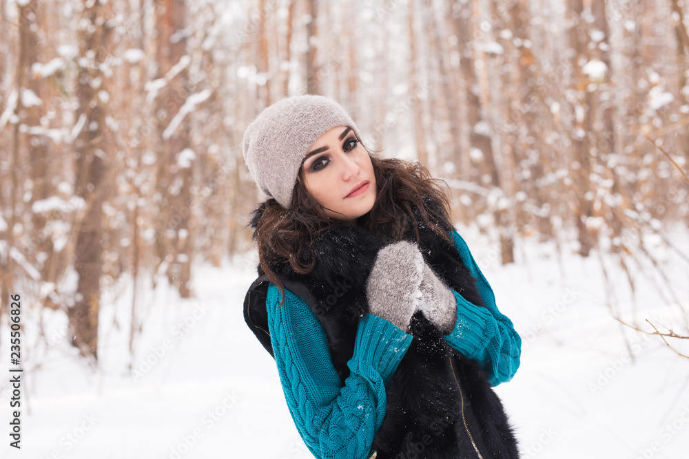 Beautiful young woman walking in the winter snowy nature Beautiful young woman walking in the winter snowy nature