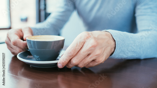 man hands holding a mug of coffee. caffeine addiction and bad habits.