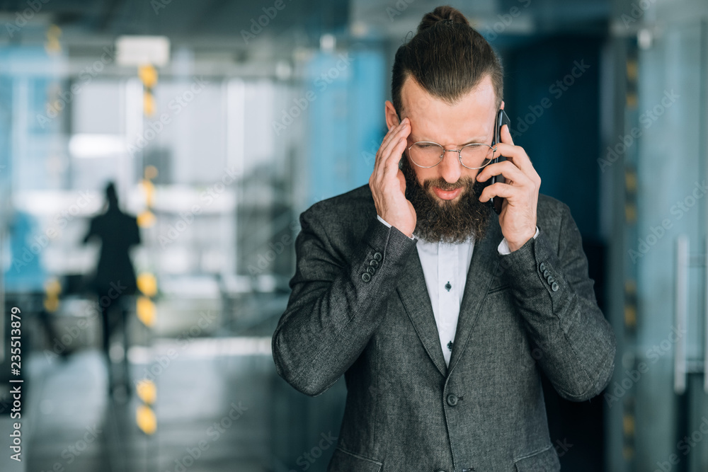 man talking on mobile. headache and unpleasant business phone call man talking on mobile. headache and unpleasant business phone call