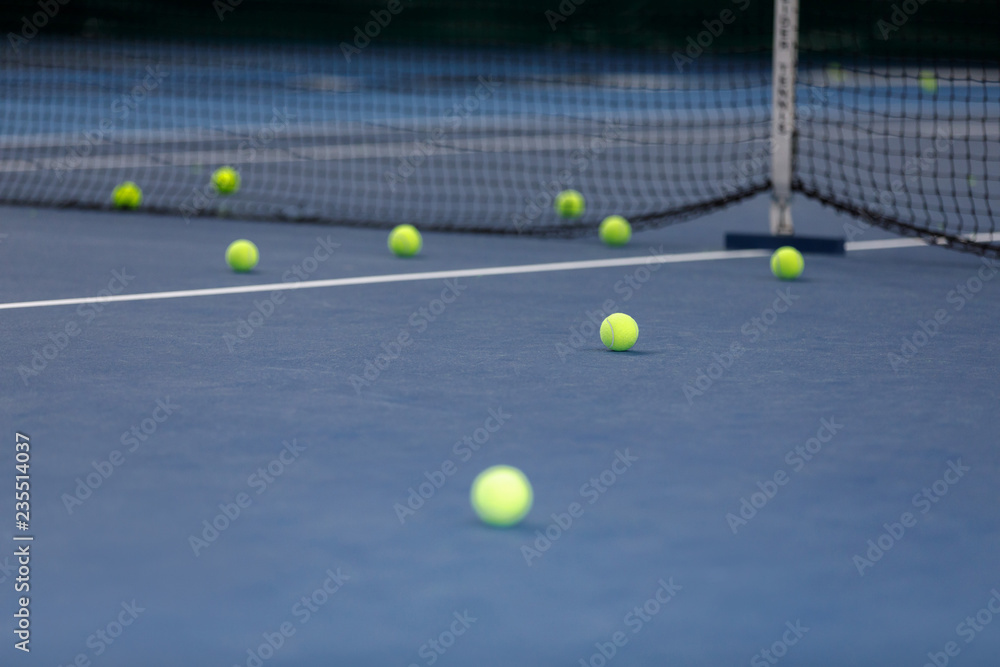 many tennis balls on the tennis court