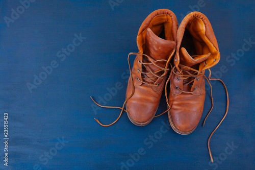 old boot red brown shoes blue top view background red leather laces high canvas dirty