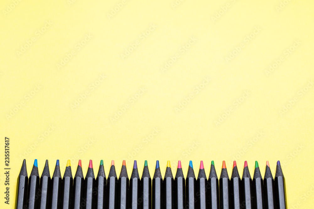 Color pencils on a yellow background close-up Color pencils on a yellow background close-up