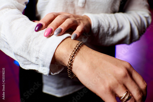 gold jewelry on the hand of a girl