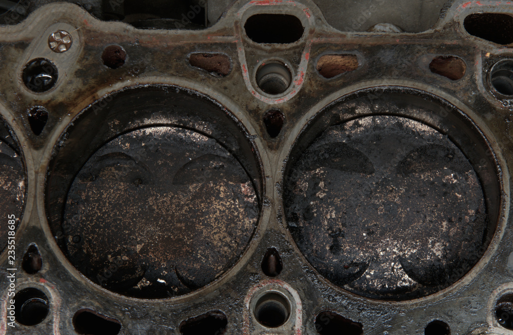 Head gasket failure on old car engine details, with carbon deposits and