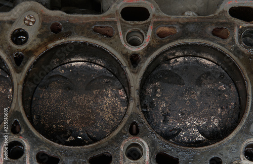 Head gasket failure on old car engine details, with carbon deposits and oil everywhere