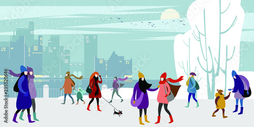 A group of young urban warmly dressed  people walk in the evening winter city quay