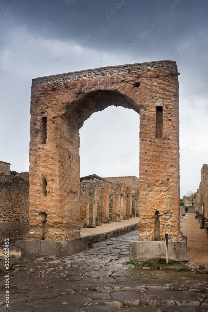 giant old arch on the central street in Pompei in Italy