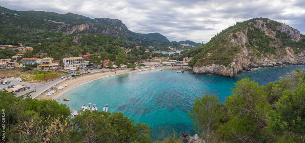 Panoramic view on beautiful Paleokastritsa bay with sand beach, forest, hills and rocks, Corfu, Kerkyra, Greece