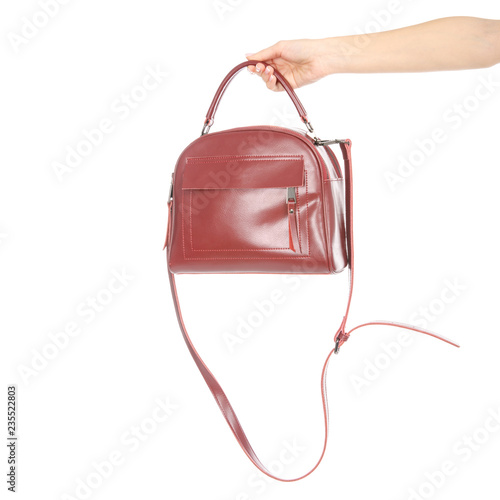 Woman's female red leather bag in hand on white background isolation