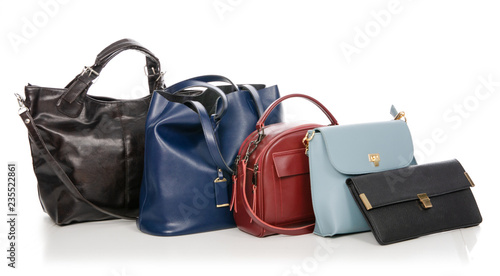 Woman's female bags pile many different on white background isolation