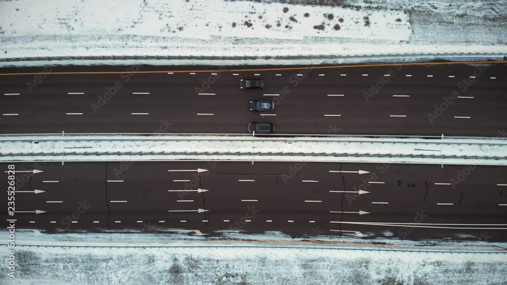 Aerial or top view from drone to winter asphalt highway or motorway road in countryside with car and truck traffic Aerial or top view from drone to winter asphalt highway or motorway road in countryside with car and truck traffic