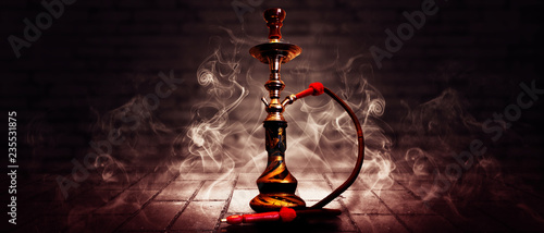 Obraz na płótnie Hookah on a dark abstract background, smoke, fog, neon, concrete, rays