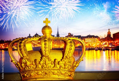 Royal crown and Stockholm cityscape at night with fiewworks, Sweden, toned