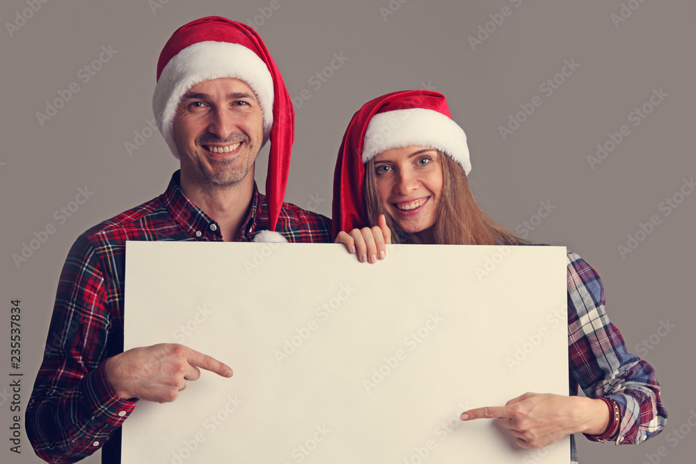 Couple in Santa hats with banner Couple in Santa hats with banner