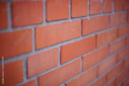 Perspective of a red brick wall, selective focus.