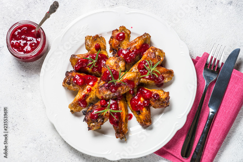 Baked chicken wings in cranberry sauce top view.  photo