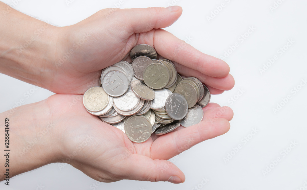 Female hands holding Russian iron coins close up isolator on a white background. a bunch of Russian coins. Russia crisis. small currency. little things Female hands holding Russian iron coins close up isolator on a white background. a bunch of Russian coins. Russia crisis. small currency. little things