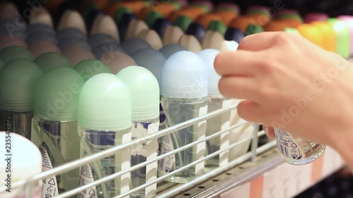 Female hands choose deodorant in the store