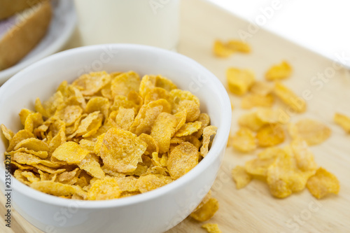 Golden Cornflakes (detailed close-up shot) on an old wooden table