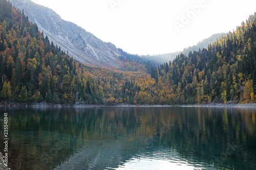 Beautiful lake surrounded by mountains and forests in autumn. Malaya Ritsa, Abkhazia.
