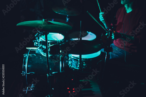 Modern drum set shot in smoky dark studio. photo