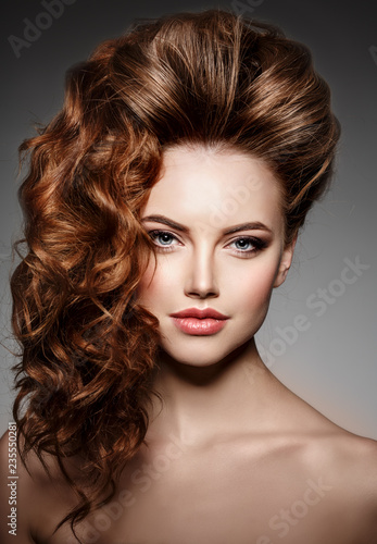 Beauty Fashion Model with long shiny hair. Waves & Curls volume Hairstyle. Hair Salon. Updo. Woman with healthy hair girl with luxurious Updo haircut. Hair loss.