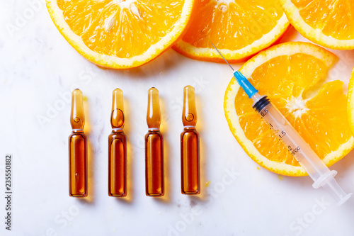 Obraz na płótnie Vitamin C, natural anti aging cosmetics serum ampullas and syringe