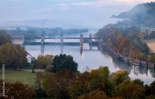 Morning view on weir over river Neckar with fog in the distance  seen from castle Horneck  Gundelsheim  Germany