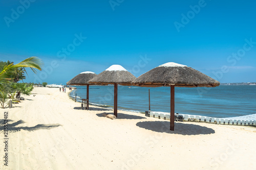Three straw parasol  on tropical and paradisiac beach