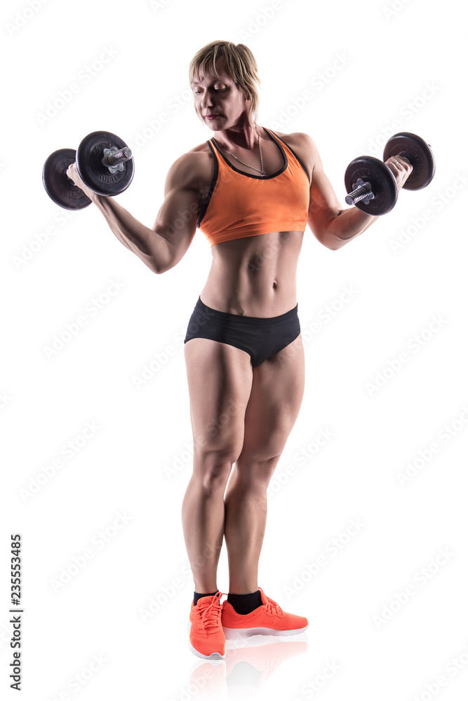 Obraz premium Sporty woman does the exercises with dumbbells on white background. Photo of muscular woman in sportswear on white background. Strength and motivation.