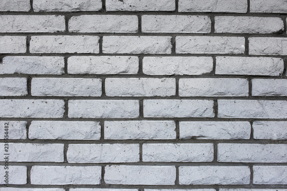Fototapeta premium Natural vintage grungy white or grey seamless brick wall. A concept of grunge, material, aged