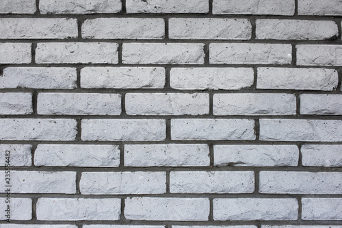 Natural vintage grungy white or grey seamless brick wall. A concept of grunge, material, aged