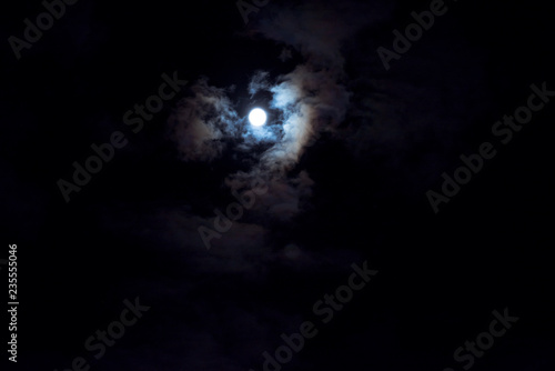 Clouds passing by moon at night. Full moon at night with clouds. Beautiful nightly spooky background.