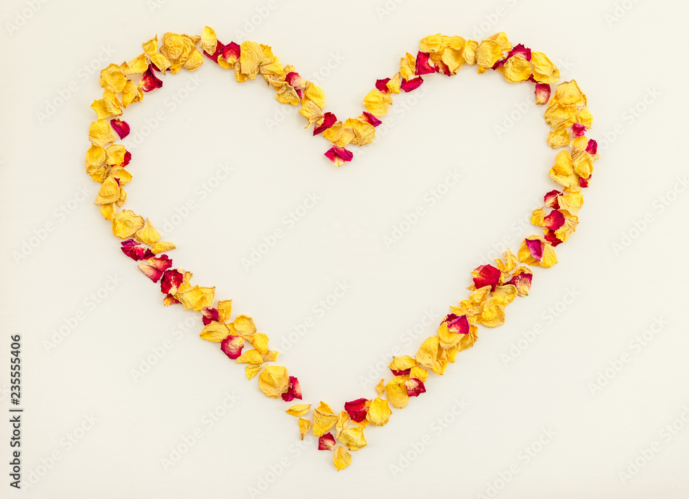 Heart made of yellow and red rose petals