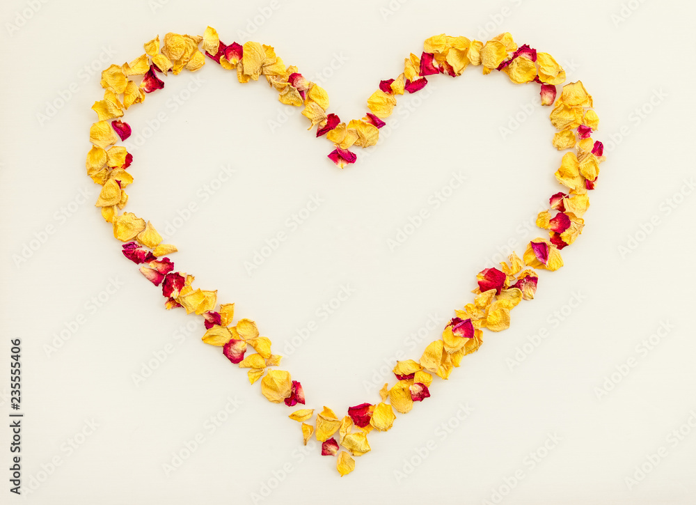 Heart made of yellow and red rose petals Heart made of yellow and red rose petals