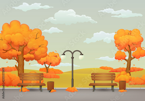 Autumn day park scene. Benches, trash cans and street lamp on an asphalt park trail with orange and yellow trees and bushes. Withered grass and gray sky with clouds on the background.