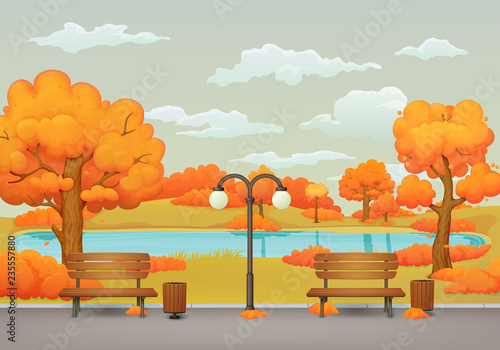 Autumn day park scene. Benches, trash cans and street lamp on an asphalt park trail with orange and yellow trees and bushes. Withered meadow, lake and gray sky with clouds on the background.