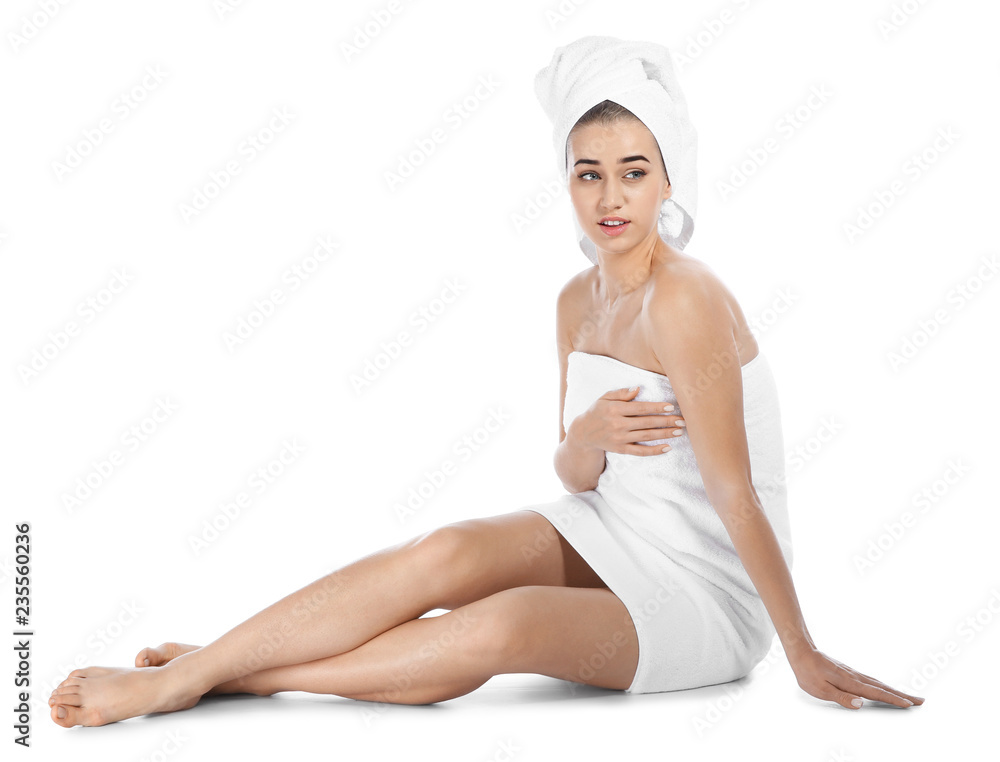 Portrait of young pretty woman with towels sitting on white background Portrait of young pretty woman with towels sitting on white background
