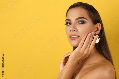 Portrait of beautiful woman with stylish makeup on color background. Space for text