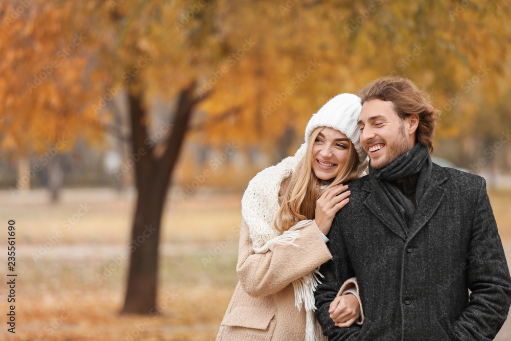 Young romantic couple in park on autumn day
