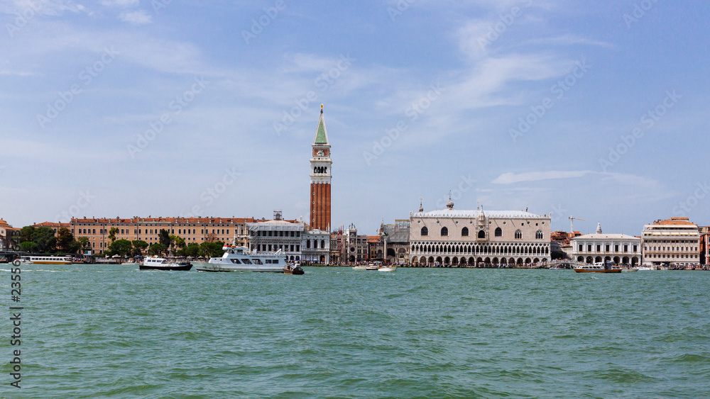 Ducal Palace and St. Mark's Bell Tower over water in Venice, Italy