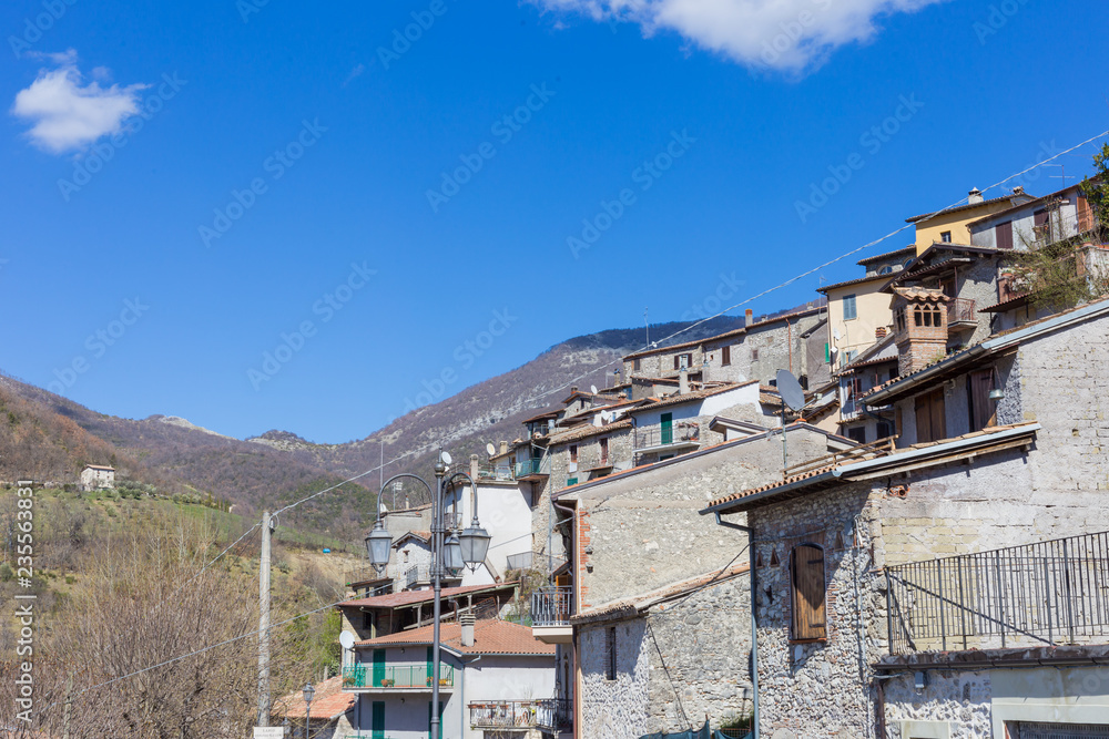 Castel di Tora and its houses perched on the mountain and the lake at its feet. Lake Turano, Lazio, Italy. Castel di Tora and its houses perched on the mountain and the lake at its feet. Lake Turano, Lazio, Italy.